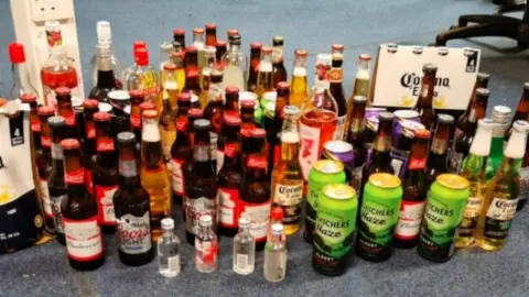 Dyfed-Powys Police Some of the alcohol which was seized in Burry Port