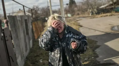 Getty Images A woman cries near Bakhmut