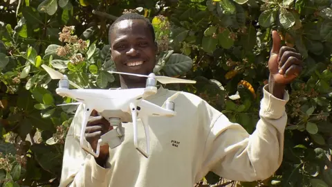 TechnoServe A cashew farmer in Benin with a drone supplied by TechnoServe