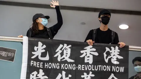 ISAAC LAWRENCE/AFP Pro-democracy demonstrators calling for the city's independence protest in Tsim Sha Tsui waterfront in Hong Kong on May 10, 2020