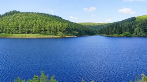 Getty Images Over the breadth of Derwent Upper Reservoir to the wooded hills of Derbyshire