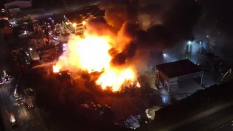 Merseyside Fire and Rescue Service Aerial shot of major fire at scrap yard