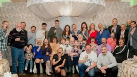 Darya Lazareva Darya Lazareva and her family pose holding up fake moustaches