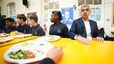 PA Media Sadiq Khan during lunchtime at his old school in Tooting Bec