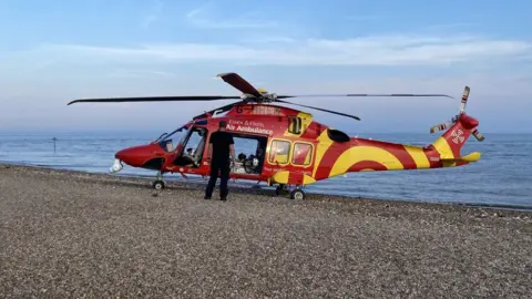Stuart Howells/BBC Air ambulance helicopter on beach