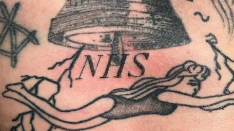 Chris Woodhead NHS tattoo