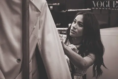 Peter Lindbergh / Vogue Meghan Markle, the Duchess of Sussex, looking at a rail of clothes