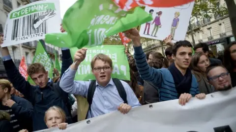 AFP Protesters wave flags at the protest in Paris