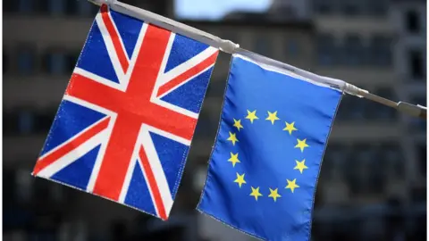 Getty Images A UK flag appears next to a European Union flag