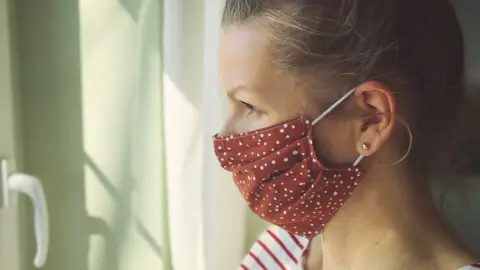 Getty Images Woman wearing a cloth face mask