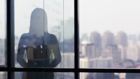 Getty Images Woman at window