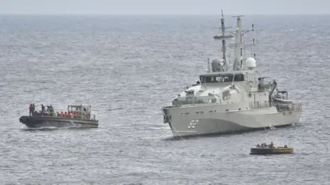Getty Images An Australian Navy vessel pictured beside an asylum seeker boat