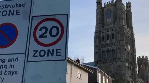 Lydia Austerfield 20mph sign with Ely Cathedral in background