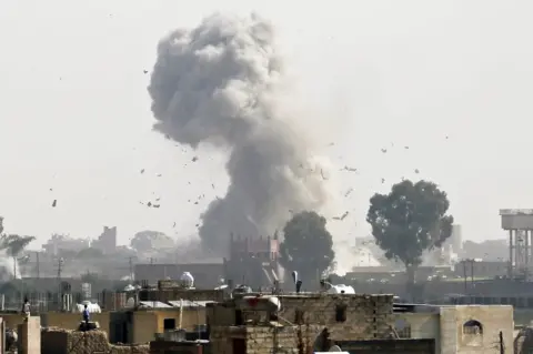 EPA Smoke rises above Sanaa, Yemen following a Saudi-led coalition air strike targeting a Houthi rebel position (31 August 2016)