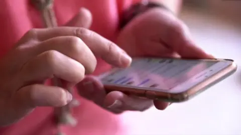 Woman's hand using a mobile phone