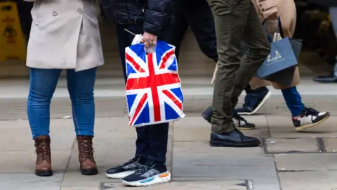 Getty Images Shoppers on a UK high street in December