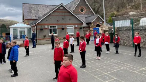 Silence at Ysgol Bodafon in Llandudno observed in the playground