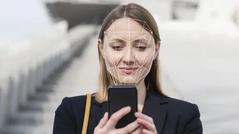 Getty Images Woman using facial recognition on phone