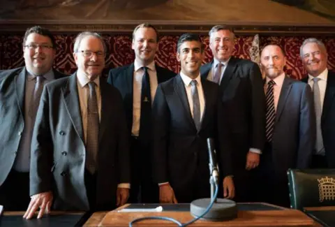 PA Media Rishi Sunak posed with members of the 1922 committee