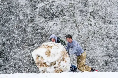 Anthony Morris Rolling a giant snowball down the hill at South Park.