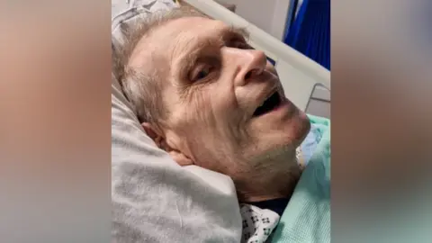 FAMILY PHOTO Grandad Melvyn Ryan was strapped to a plank of wood after he broke his hip