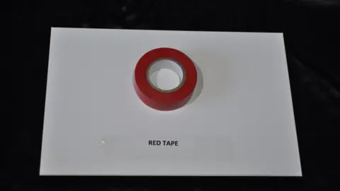 Trevor Prideaux A reel of red insulation tape