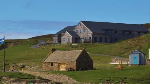 Fair Isle bird observatory The Fair Isle bird observatory, pictured in the background, has recorded the migration patterns of birds.