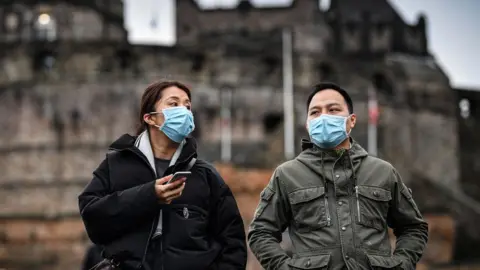 Getty Images women wearing face masks at Edinburgh castle