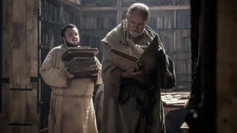 HBO/Sky A still from the television series Game of Thrones showing two characters in a library