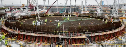 PA Media The base for the first reactor at Hinkley Point C