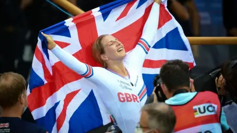 Getty Images Great Britain's Neah Evans celebrates her victory after winning the Women's Points Race 25km final during the UCI Track Cycling World Championships at the Velodrome of Saint-Quentin-en-Yvelines, southwest of Paris, on October 16, 2022