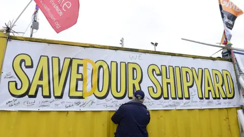 PAcemaker Man signing 'Saved our Shipyard' poster at Harland and Wolff