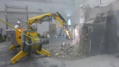 DSRL Robotic machine demolishing parts of the interior of a building at Dounreay