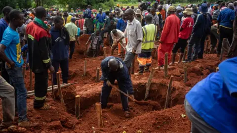 Getty Images People dig multiple graves for their relatives