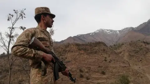 EPA File photo of Pakistani Army soldier standing guard at the Line of Control, the de facto border between Pakistani and Indian administered Kashmir in Chakothi, Azad Kashmir, Pakistan, 23 February 2019.