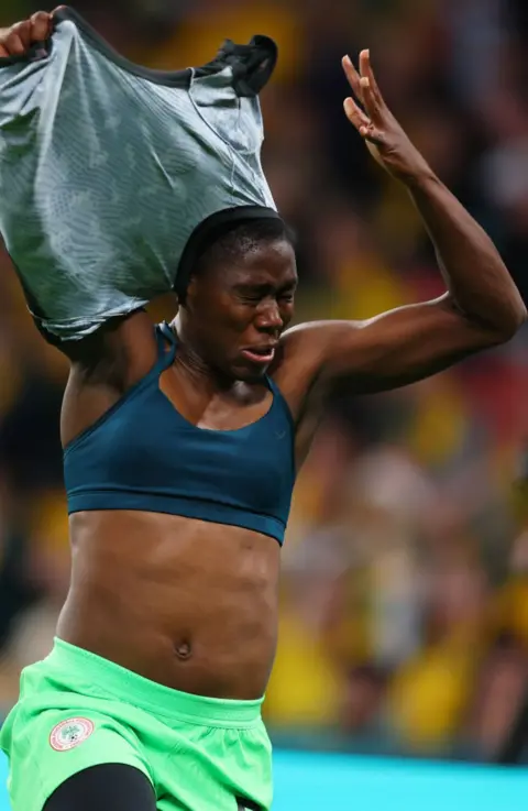 Chris Hyde/FIFA A female footballer takes her shirt off while celebrating a goal on Thursday.