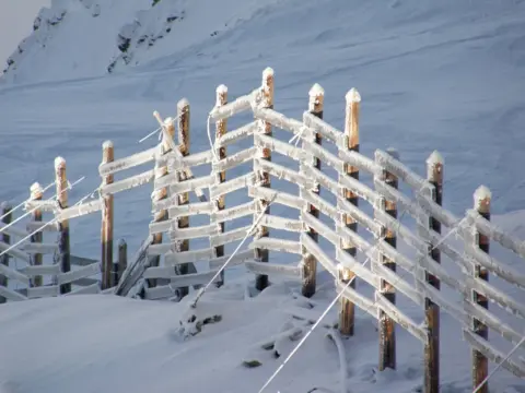 Jane Wynter A fence marking the boundary of the piste in Les Arcs, ski resort in Bourg-Saint-Maurice, France.