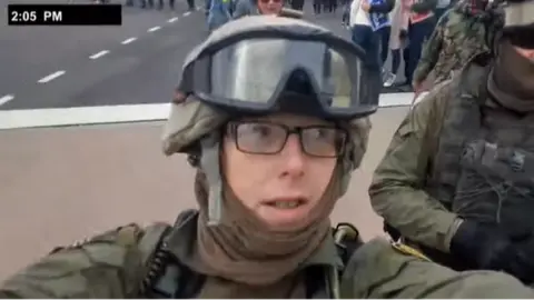 US Justice Department A still from a video shot by Jessica Watkins as she marched to the Capitol on 6 January. It shows Watkins dressed in military-style gear