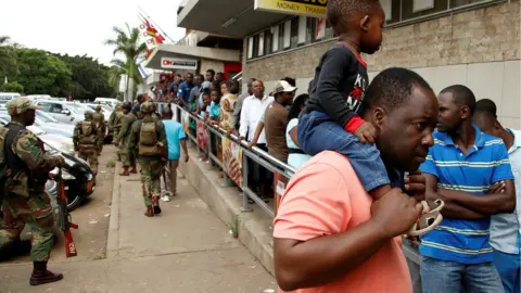 Reuters People queue at a supermarket in Harare on Wednesday