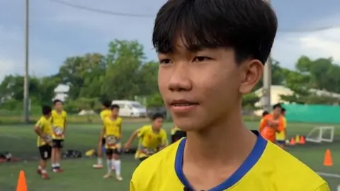 Rescued Thai boy known as "Titan" at a football field