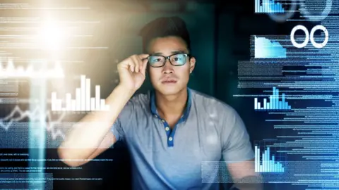 Getty Images Man surrounded by digital screens