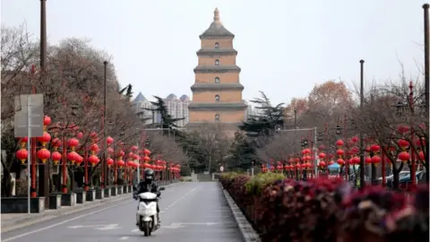 Reuters Delivery rider on the streets of Xi'an