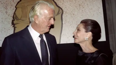 AFP/Getty Images Hubert de Givenchy (L) and Audrey Hepburn talk together at the Galliera Museum in Paris in 1991