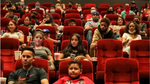 Getty Images Cinema-goers watch the premiere of Marvel's Shang-Chi and the Legend of the Ten Rings