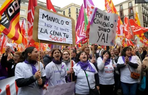 AFP/Getty Images Protesters hold a placard that reads "Manolo, today you'll do your dinner yourself!!" in Barcelona, Spain