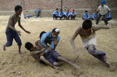 Getty Images In this photograph taken on October 5, 2016, Indian schoolchildren play Kabaddi at their government school in the village of Sarai Amanat Khan near the Indian Pakistan border, some 30kms west of Amritsar.