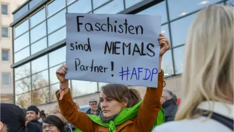 AFP People demonstrate outside Thuringia"s State parliament building with a banner reading "Fascists are never partners !"