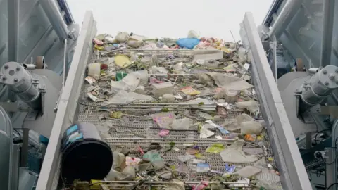 The Ocean Cleanup Plastic rubbish gathered by an Interceptor moving along a conveyor belt
