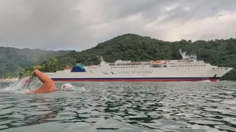 Andy Donaldson Andy Donaldson swims alongside the inter-Island ferry between New Zealand's North and South Islands