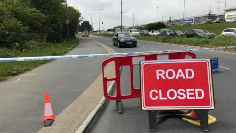 BBC Closed road at crash scene.